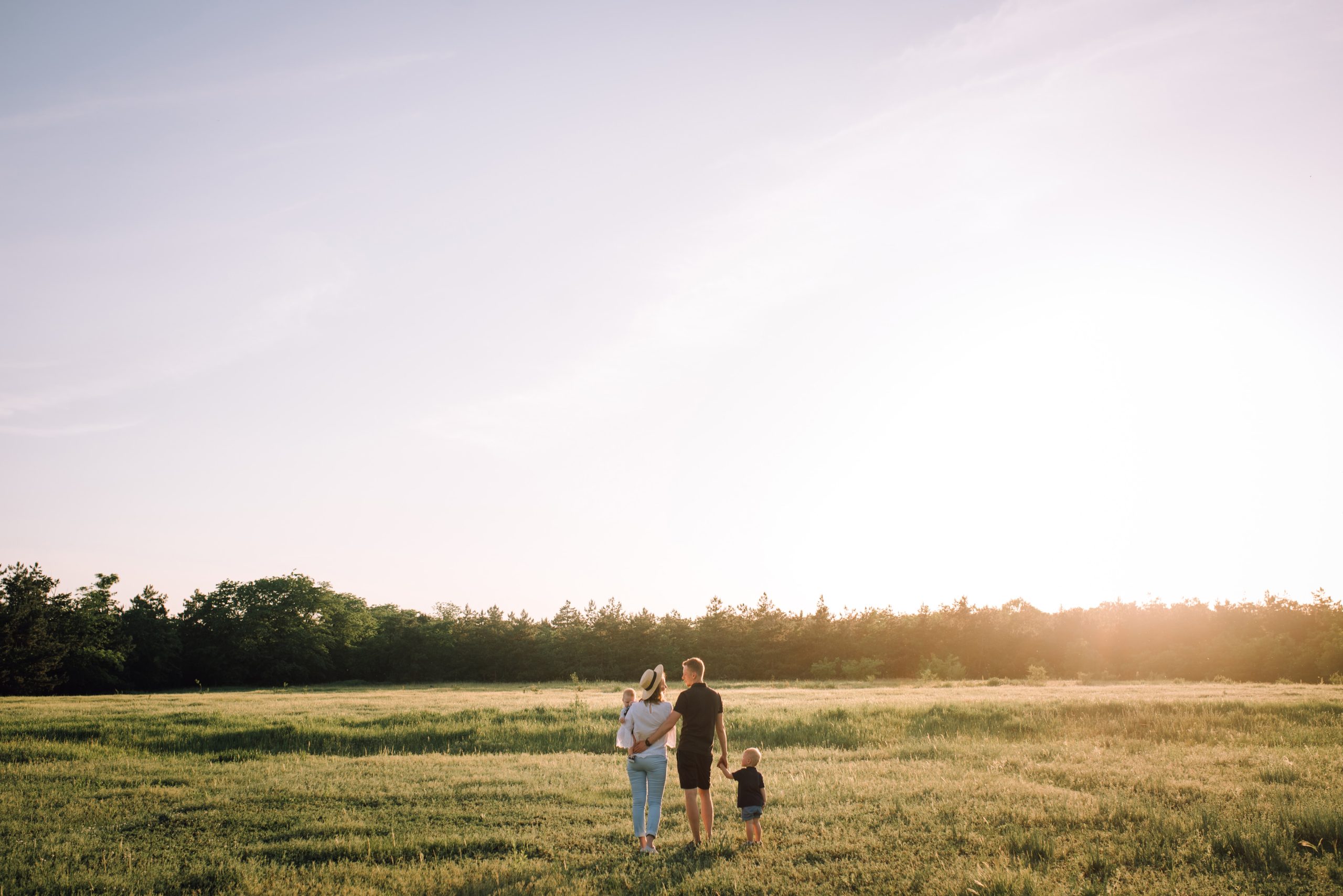Family walking together in a wide open field